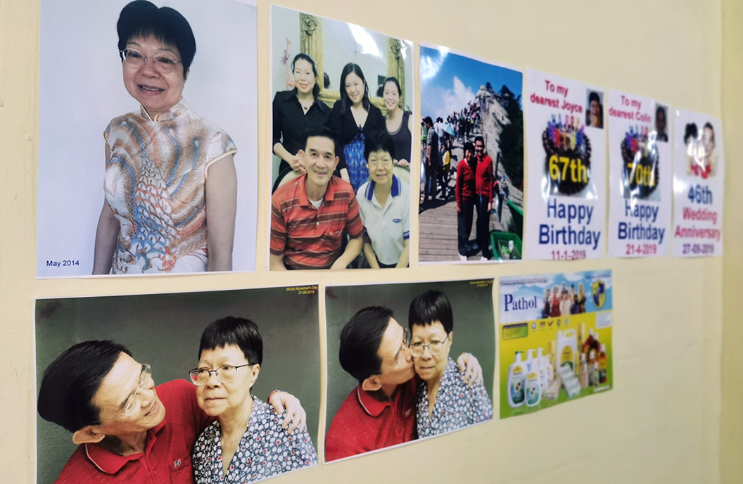 Colin puts up pics of their family on the wall on the house to stimulate Joyce’s memory