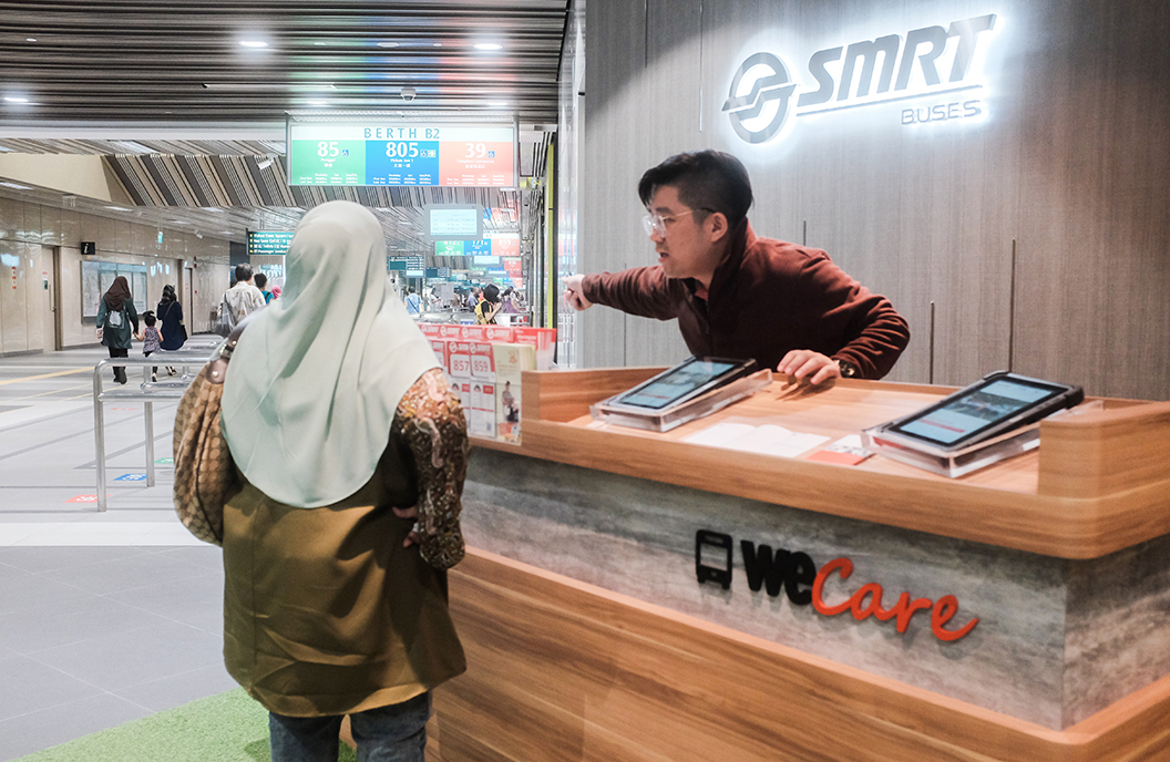 Staff at the counter at Yishun ITH, helping a commuter out